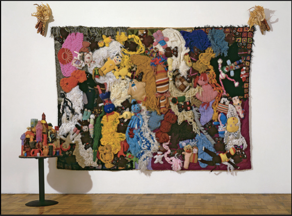 More Love Hours Than Can Ever Be Repaid and The Wages of Sin, 1987, found handmade stuffed animals and afghans on canvas, dried corn, wax candles on wood, metal base, 2 parts, 96 x 127 x 5 in.; 52 x 23 x 23 in. Installation view Rosamund Felsen Gallery, Los Angeles; Photo by Douglas M. Parker; Courtesy Mike Kelley Foundation of Arts ©Estate of Mike Kelley.