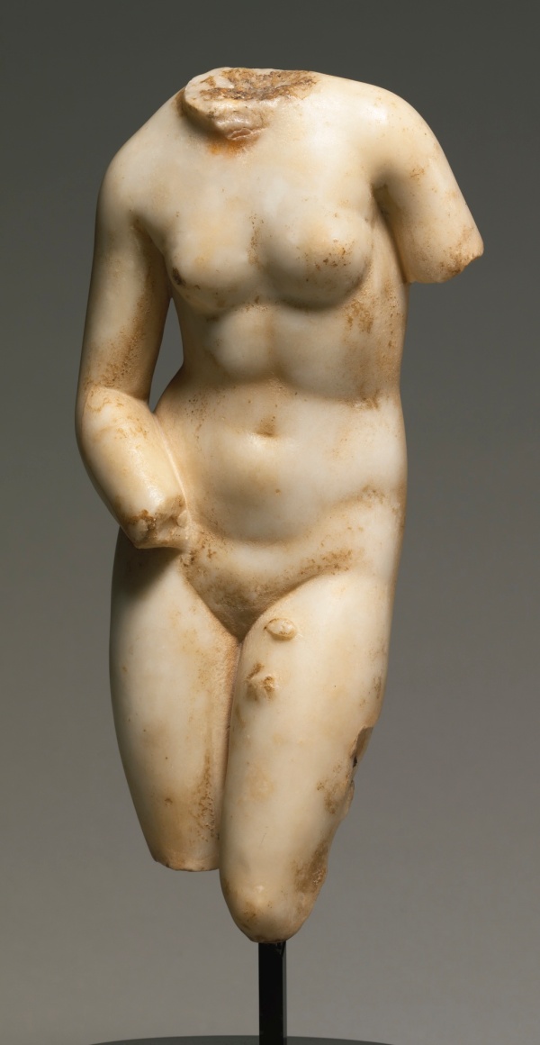 Lot 5. A MARBLE TORSO OF APHRODITE, ROMAN IMPERIAL, CIRCA 1ST CENTURY A.D. inspired by the Aphrodite of Knidos by Praxiteles, circa 350 B.C., the goddess standing with her weight on the right leg and bending forward slightly at the waist, her right forearm resting on her hip, the iron dowel on the left leg for attachment to a missing support. 13 1/4 in. 33.7 cm. Estimate: $80,000-120,000. Click on image to enlarge.